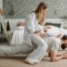 A joyful family enjoys playful bonding in a cozy bedroom, enhancing love and togetherness.