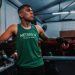 A determined young boxer rests on the ring ropes at a boxing gym in Buenos Aires, Argentina.